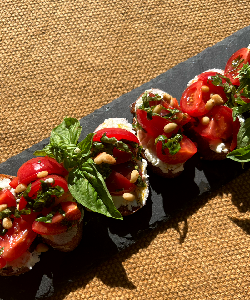 Shadow of Wine Glass of Tomato Goat Cheese Toasts